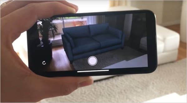 camera showing augmented reality picture of a couch.